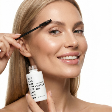 Woman holding Nanolash castor oil and applying the product to her eyebrow