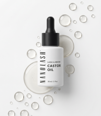 Bottle of Nanolash castor oil on a light background with drops