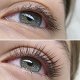 Comparison of two green eyes, the one below has lifted lashes